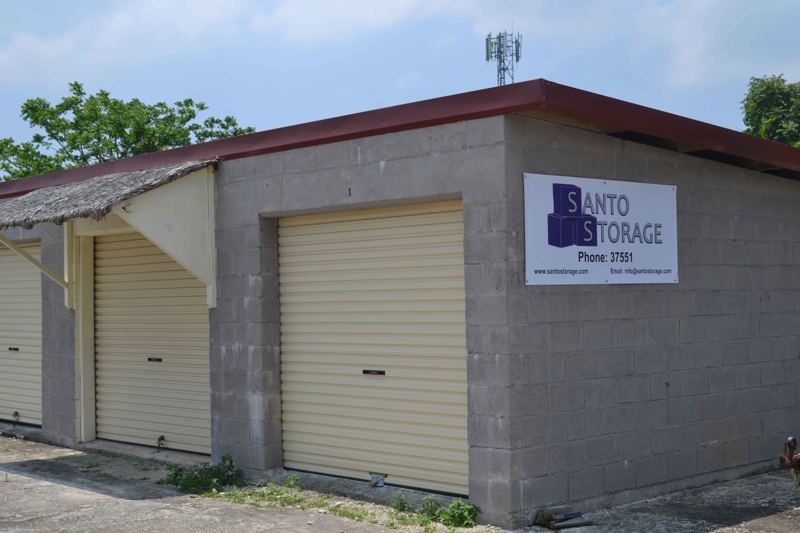 Santo Storage sheds in Luganville: a concrete-block building with roller doors and the Santo Storage sign